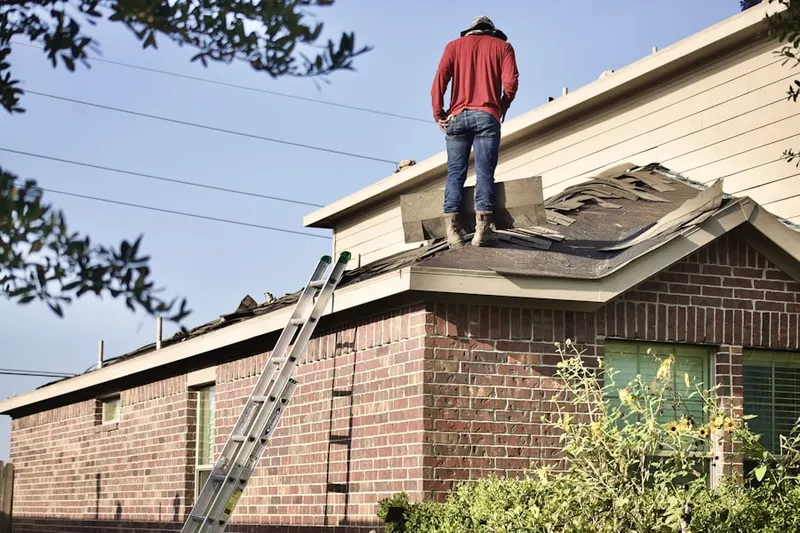 Professional roofer working on a residential roof in Adelanto